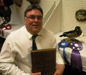 Terry Winter holding an award plaque